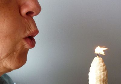 Person blowing out a candle