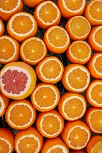 Photograph of lots of oranges plus one grapefruit