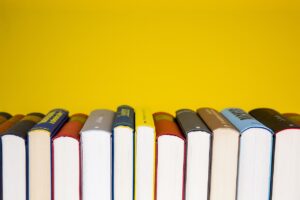 Colourful photograph of a stack of books meant to convey an idea of research