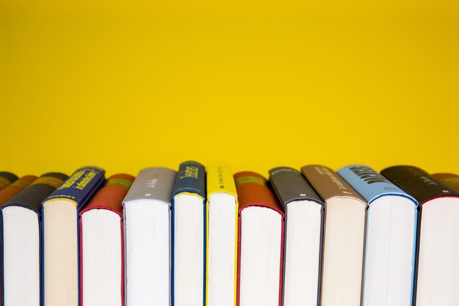 Colourful photograph of a stack of books meant to convey an idea of research
