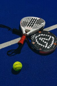 Photo of two Padel racquets and a ball